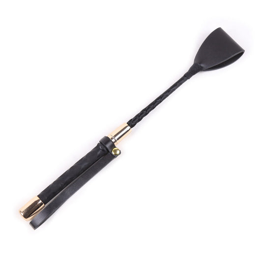 Chicote Fouet NuAuge preto de couro PU com cabo trançado e detalhes dourados.