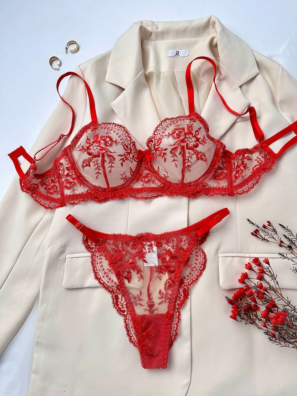 Frente do Conjunto Florinda vermelho: sutiã meia-taça com aro, tule transparente e bordado floral; calcinha fio.